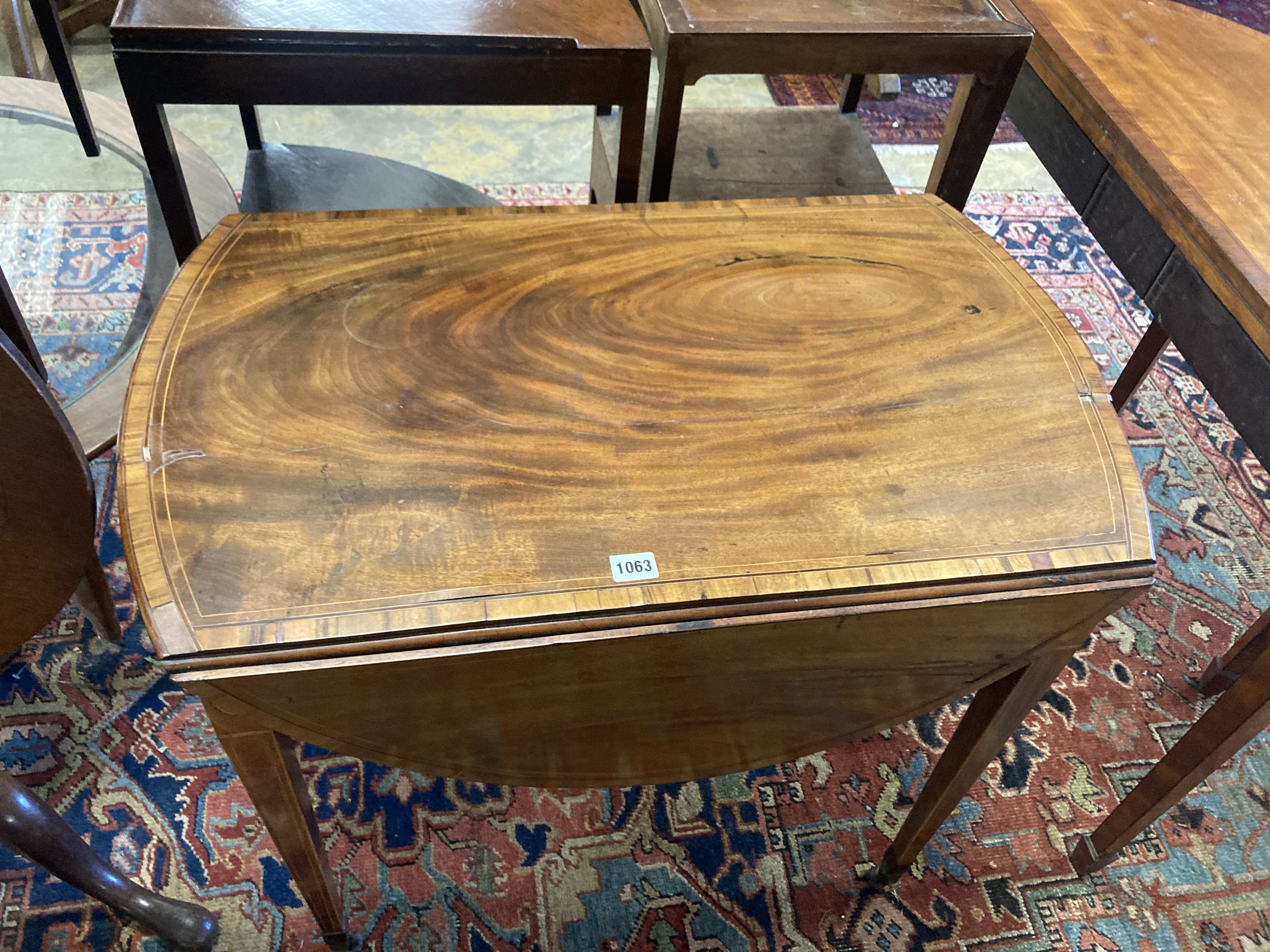 A George III rosewood banded and inlaid mahogany oval Pembroke table, width 79cm depth 49cm, height 68cm